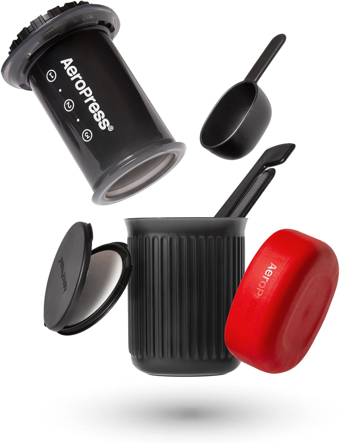Aeropress coffee maker with components on a white background