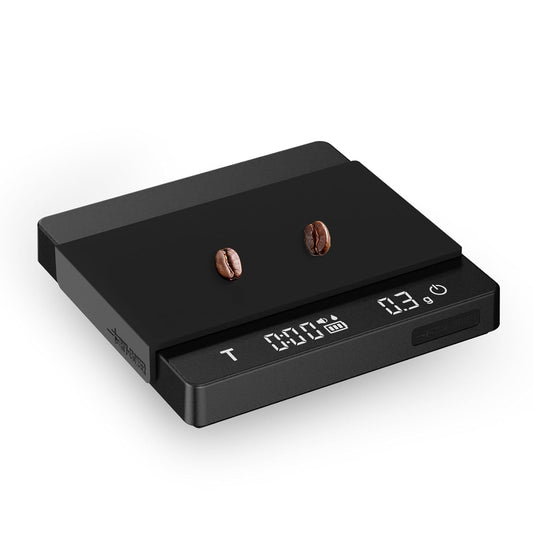 Digital coffee scale with two coffee beans on a white background
